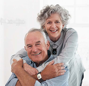 senior couple wearing medical alert bracelet and necklace