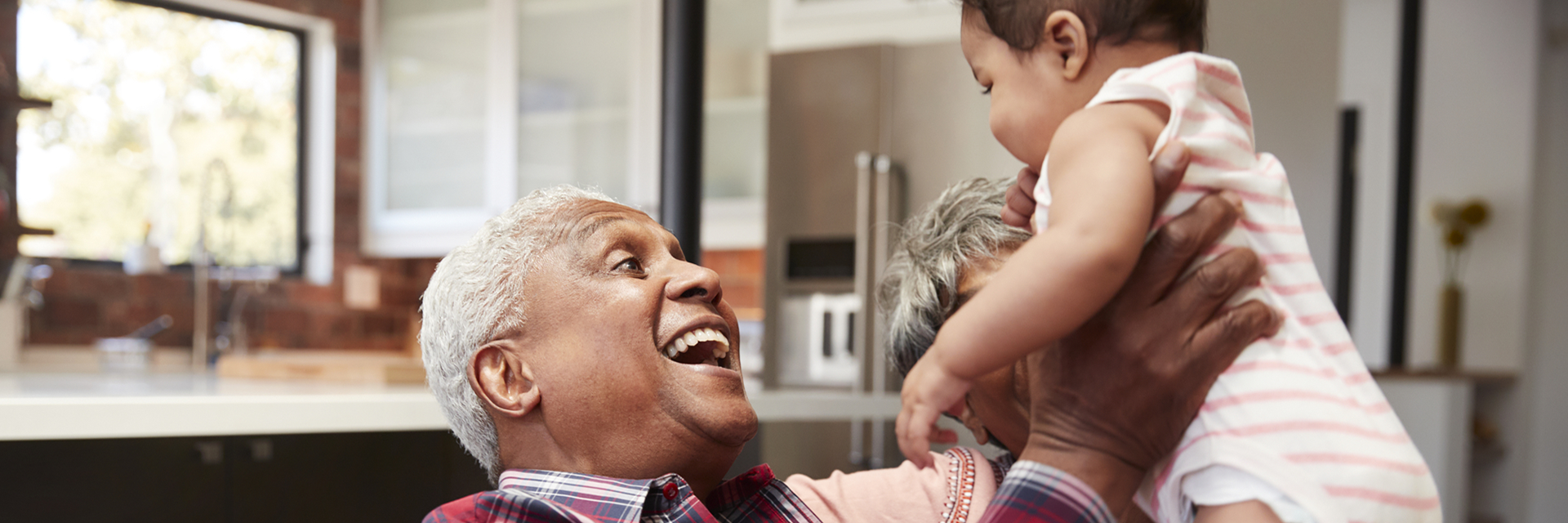 Happy Grandfather holding baby