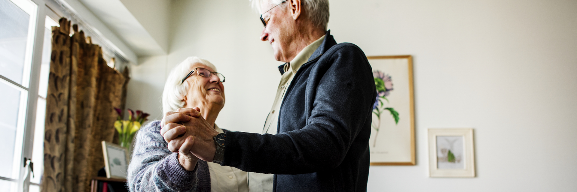 Happy Senior Couple slow dancing at home